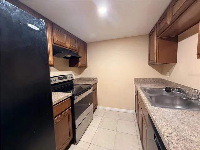 a kitchen with a sink stove and refrigerator