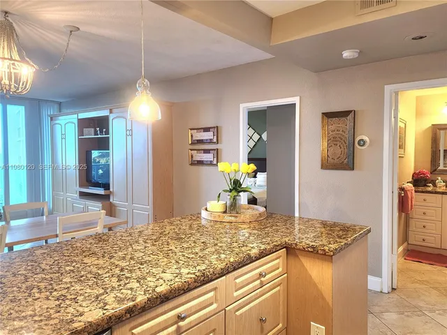 a kitchen with kitchen island granite countertop sink and granite counter tops