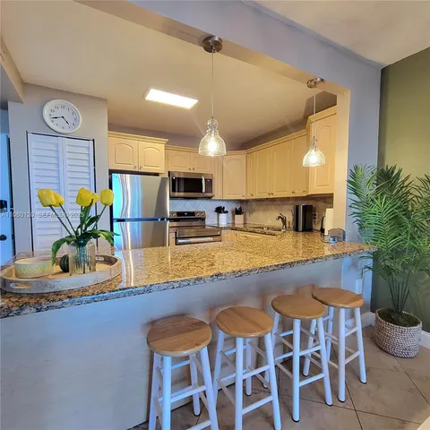 a kitchen with a table and chairs in it