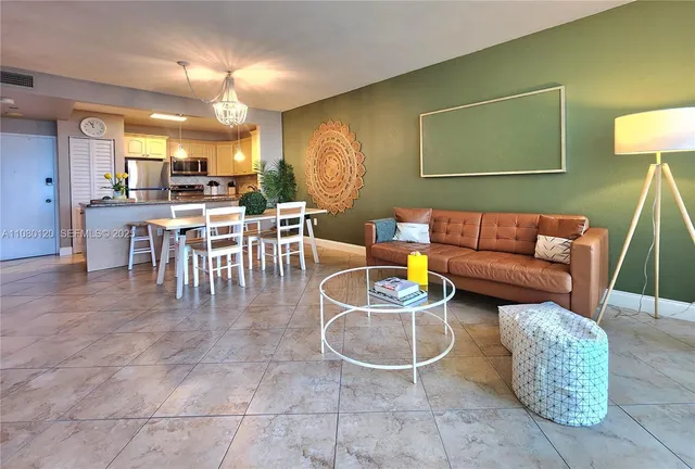 a living room with furniture a lamp and a table