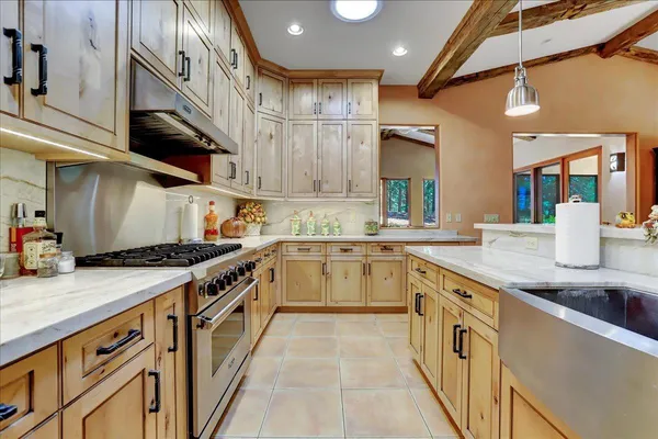 a living room with furniture and large windows