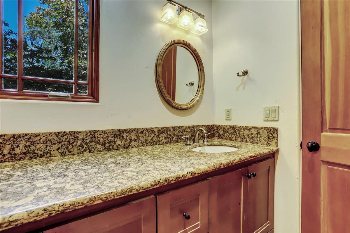 18955 Lake City Road Nevada City, CA 95959 - Photo 29 of 99 a bathroom with a granite countertop sink and a mirror