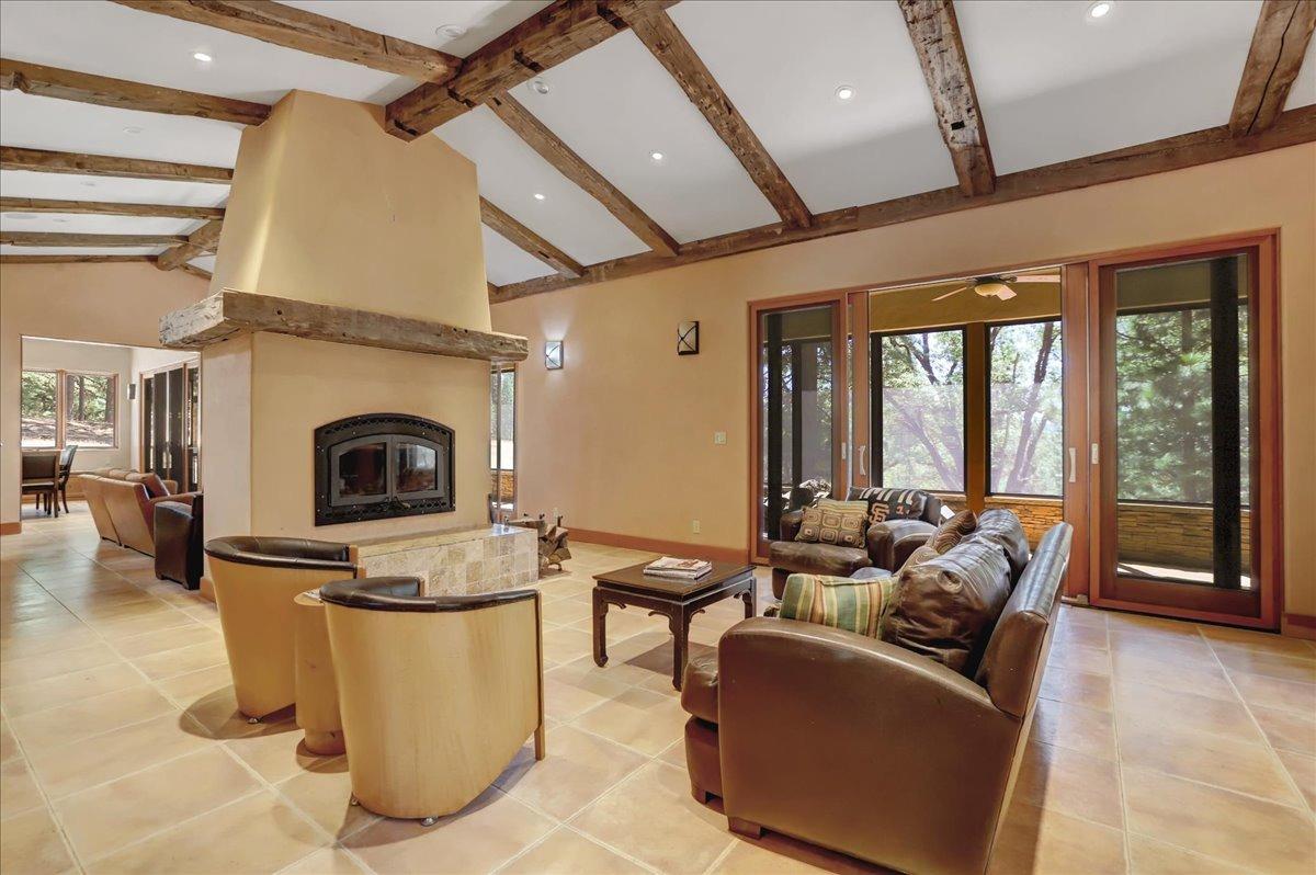 18955 Lake City Road Nevada City, CA 95959 - Photo 3 of 99 a living room with furniture a fireplace and a flat screen tv