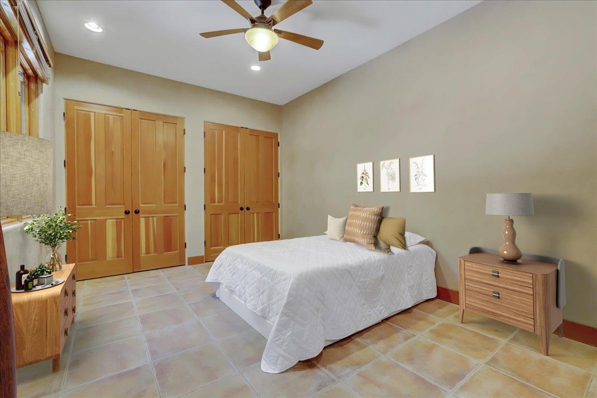18955 Lake City Road Nevada City, CA 95959 - Photo 32 of 99 a bedroom with a bed and a chandelier
