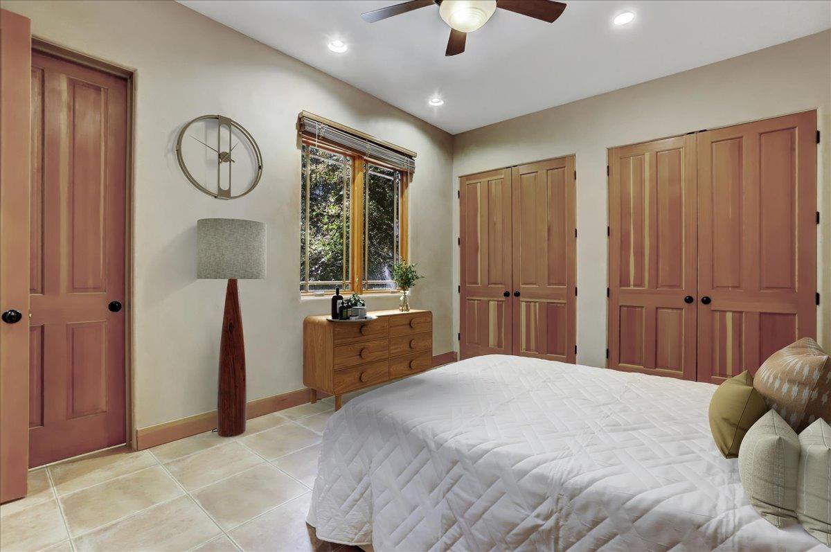 18955 Lake City Road Nevada City, CA 95959 - Photo 33 of 99 a bedroom with a large bed and a chandelier