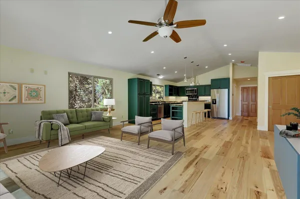 a view of a yard with plants and trees