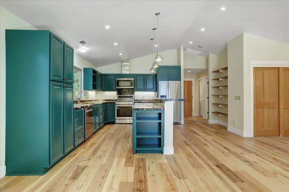 18955 Lake City Road Nevada City, CA 95959 - Photo 46 of 99 a kitchen with stainless steel appliances kitchen island granite countertop a refrigerator and a wooden floors
