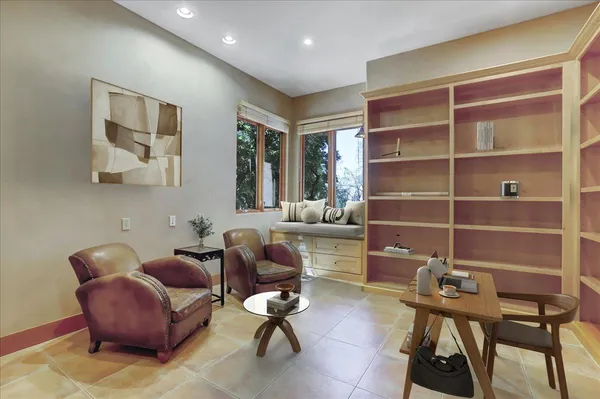 a living room with furniture and large window with outer view