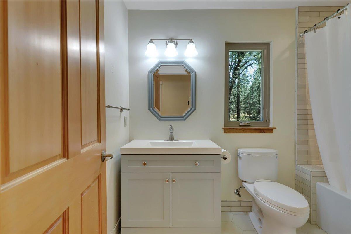 18955 Lake City Road Nevada City, CA 95959 - Photo 53 of 99 a bathroom with a toilet sink and mirror