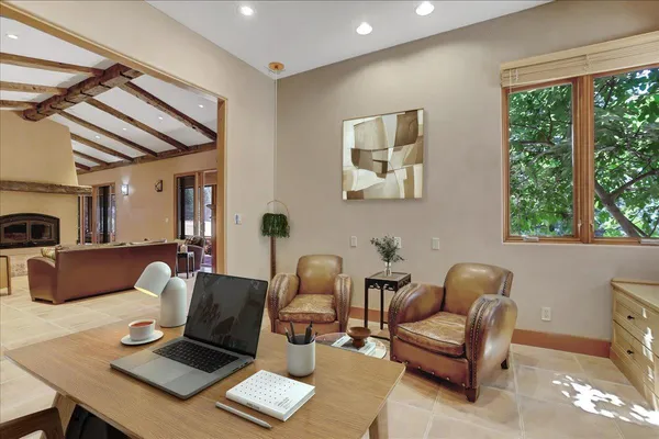 a living room with furniture a rug and a large window