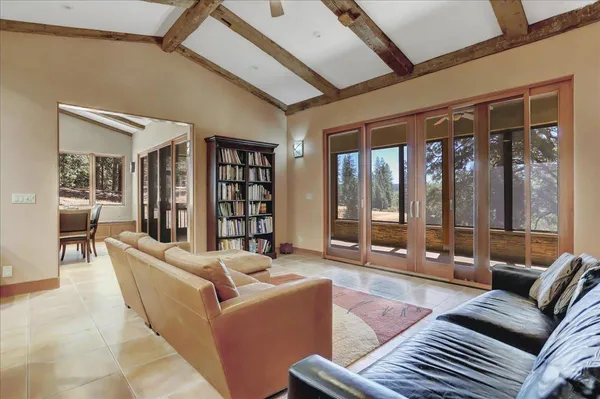 a living room with furniture and a view of kitchen