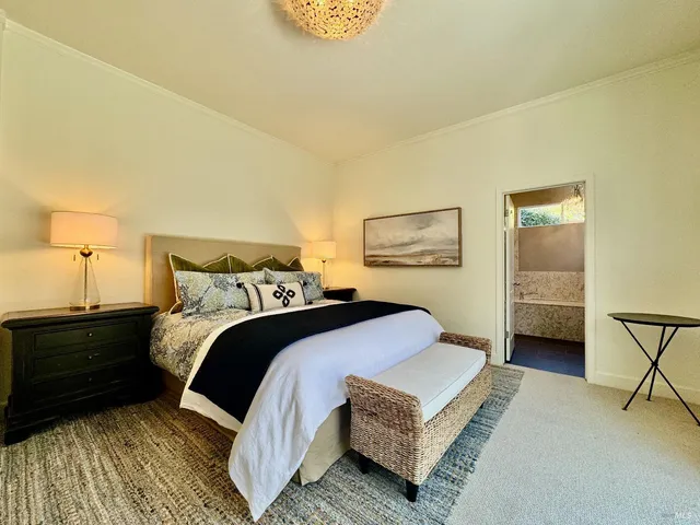 a bedroom with a bed and lamp