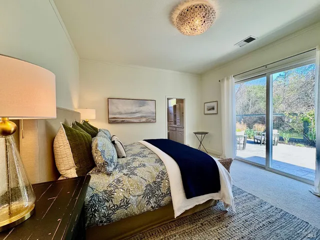 a bed room with a bed and a large window