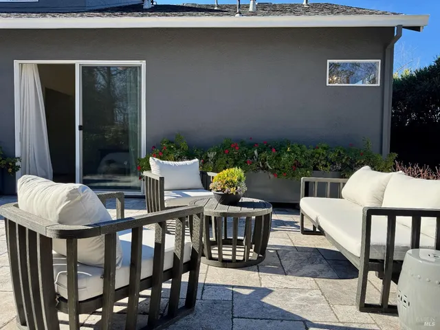 a view of a chairs and table in patio