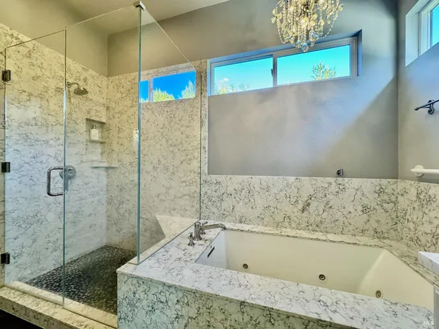 a bathroom with a bathtub and a shower