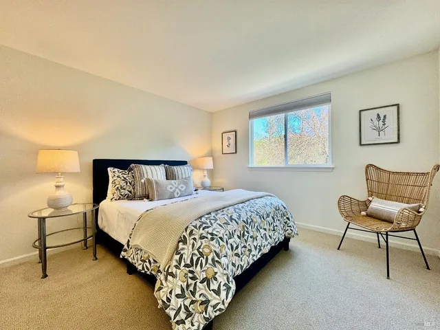 a bedroom with a bed and chair