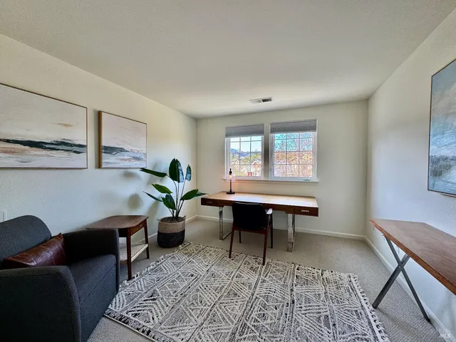 a living room with furniture a window and a table