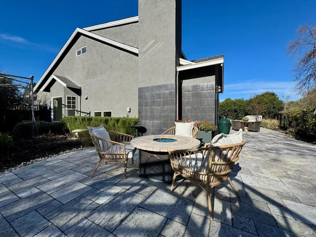 a view of backyard with outdoor seating a patio and plants