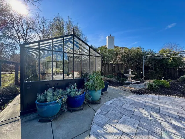 a view of a patio with couches and potted plants