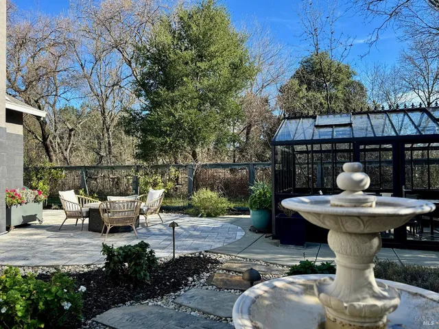 a view of a back yard of the house with green space
