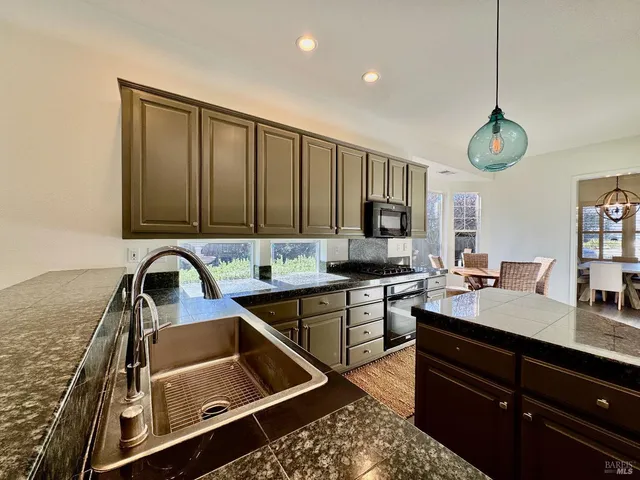 a kitchen with a sink cabinets and window