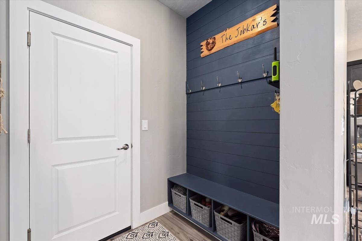 815 Knowledge Street Middleton, ID 83644 - Photo 20 of 49 Built-in mudroom bench with integrated storage cubbies, shiplap-style accent wall, and coat hooks