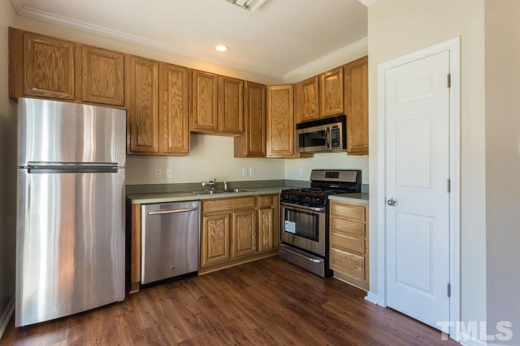 5110 Neuse Commons Lane, Unit 100 Raleigh, NC 27616 - Photo 12 of 27 a kitchen with a refrigerator stove top oven and sink