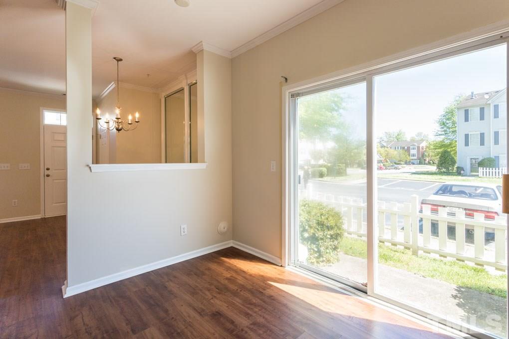 5110 Neuse Commons Lane, Unit 100 Raleigh, NC 27616 - Photo 15 of 27 a view of a room with wooden floor and windows