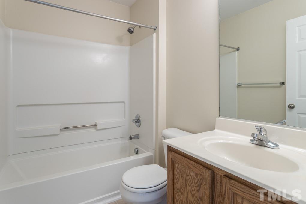 5110 Neuse Commons Lane, Unit 100 Raleigh, NC 27616 - Photo 17 of 27 a bathroom with a sink a toilet and shower
