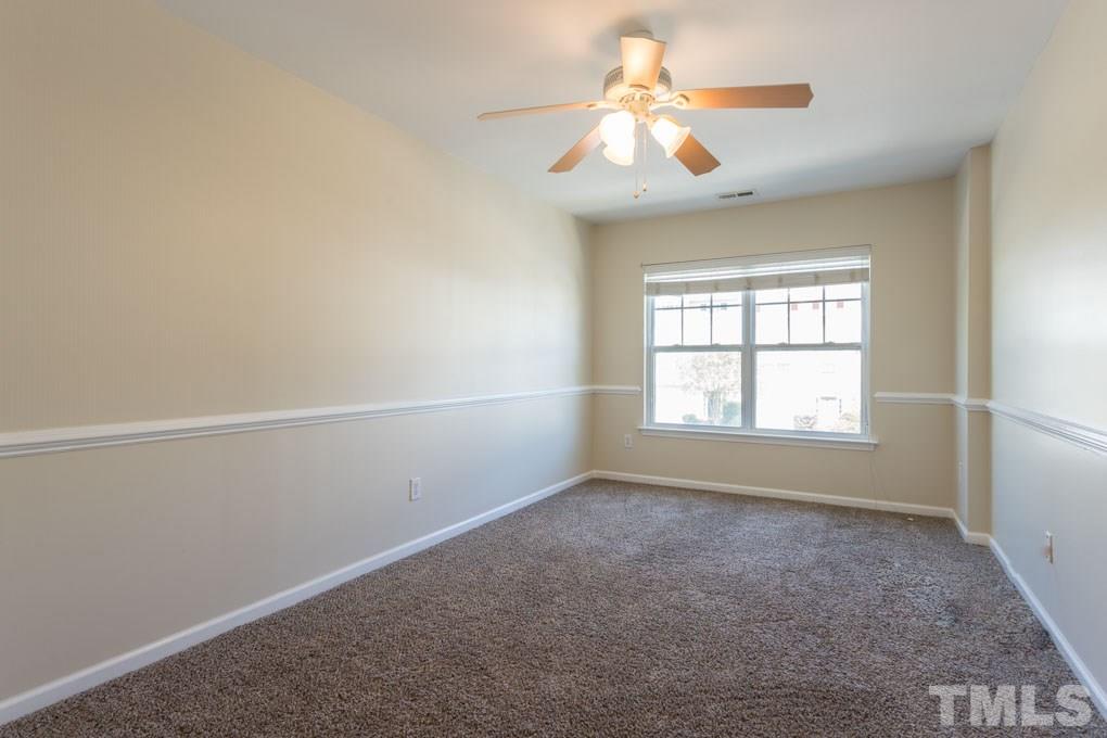 5110 Neuse Commons Lane, Unit 100 Raleigh, NC 27616 - Photo 20 of 27 an empty room with a window and a fan