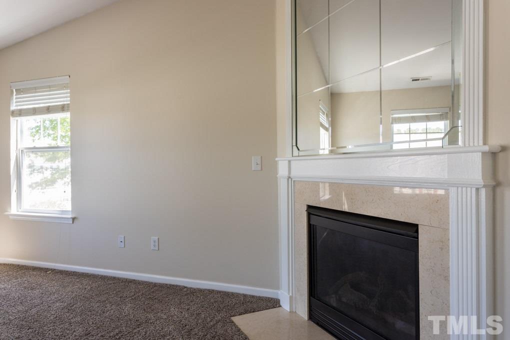 5110 Neuse Commons Lane, Unit 100 Raleigh, NC 27616 - Photo 23 of 27 a living room with a fireplace in it