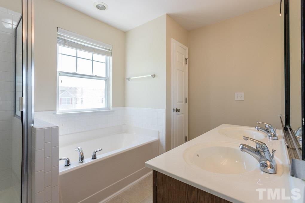5110 Neuse Commons Lane, Unit 100 Raleigh, NC 27616 - Photo 26 of 27 a bathroom with a sink and a bathtub