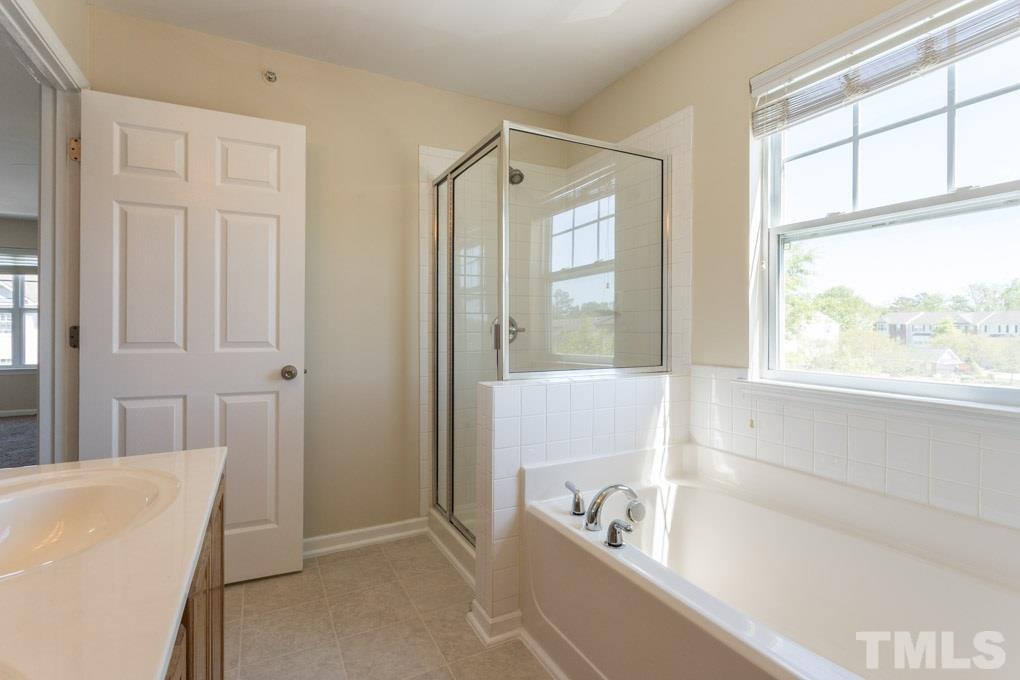 5110 Neuse Commons Lane, Unit 100 Raleigh, NC 27616 - Photo 27 of 27 a bathroom with a tub a sink and a window