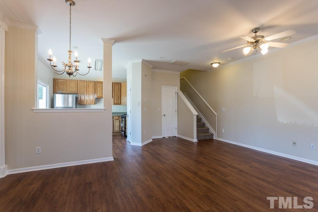 5110 Neuse Commons Lane, Unit 100 Raleigh, NC 27616 - Photo 6 of 27 a view of a livingroom with wooden floor and staircase