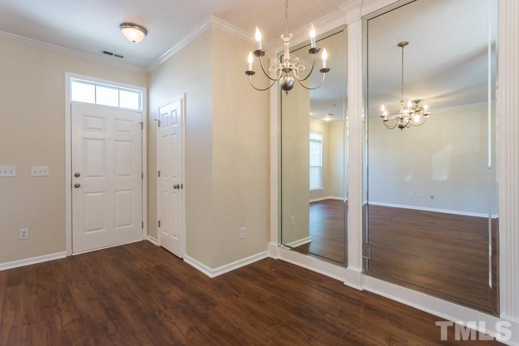 5110 Neuse Commons Lane, Unit 100 Raleigh, NC 27616 - Photo 7 of 27 wooden floor in an empty room with a mirror