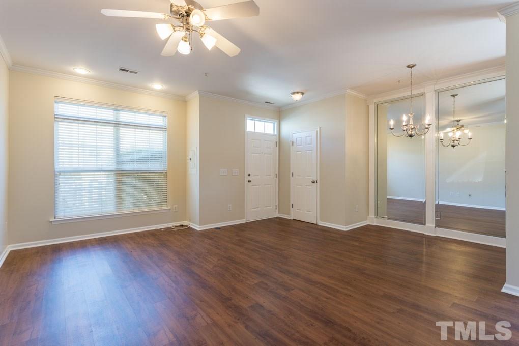 5110 Neuse Commons Lane, Unit 100 Raleigh, NC 27616 - Photo 9 of 27 a view of an empty room with window and wooden floor