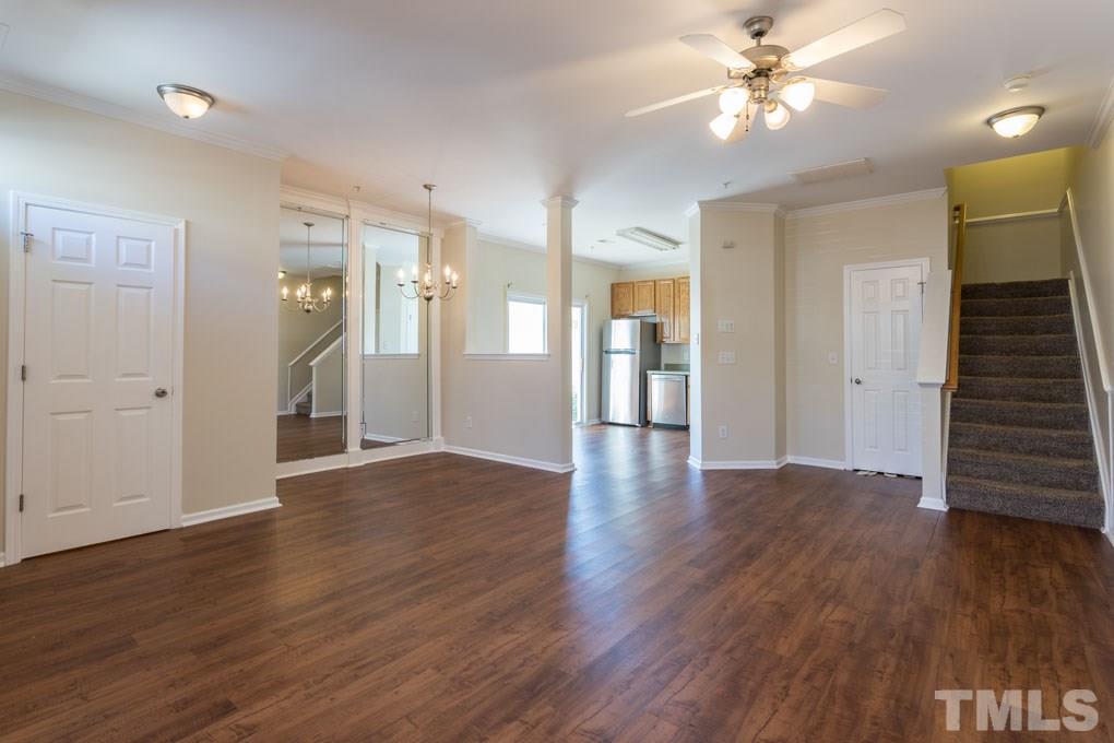 5110 Neuse Commons Lane, Unit 100 Raleigh, NC 27616 - Photo 10 of 27 an empty room with wooden floor and ceiling fan