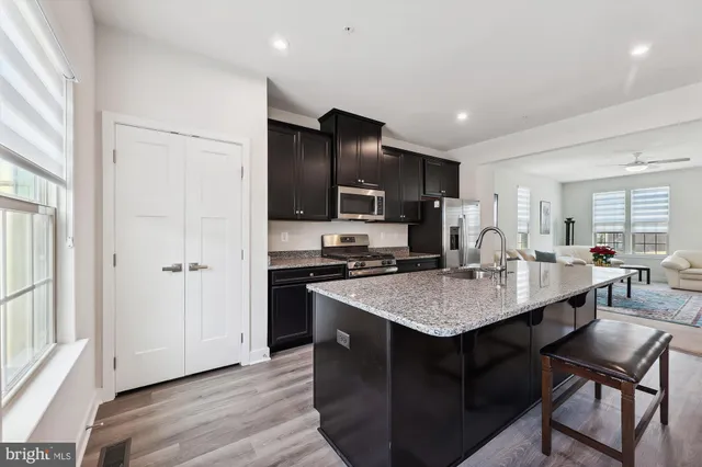 a kitchen with cabinets and stainless steel appliances