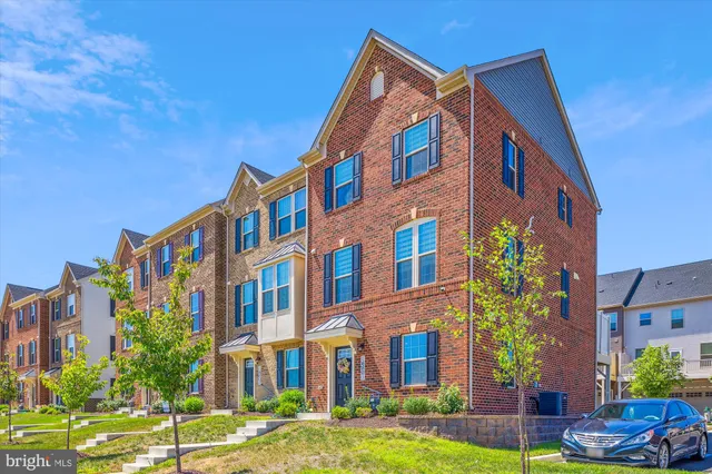 a front view of a multi story residential apartment building with yard
