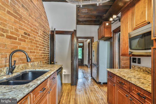 a kitchen with stainless steel appliances granite countertop a sink a counter space and stainless steel appliances