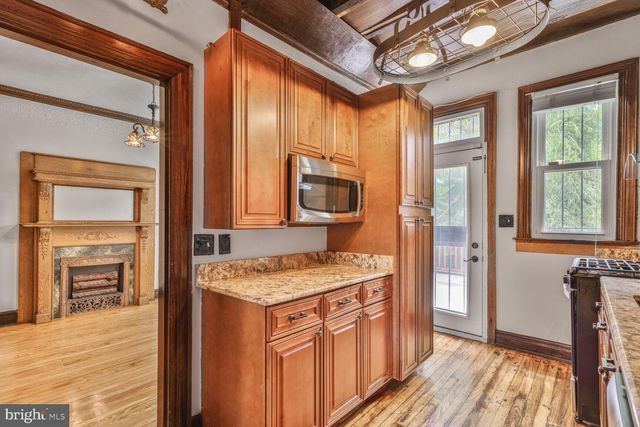 a kitchen that has a stove a sink and a refrigerator