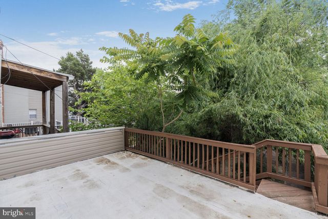 a view of a balcony with yard