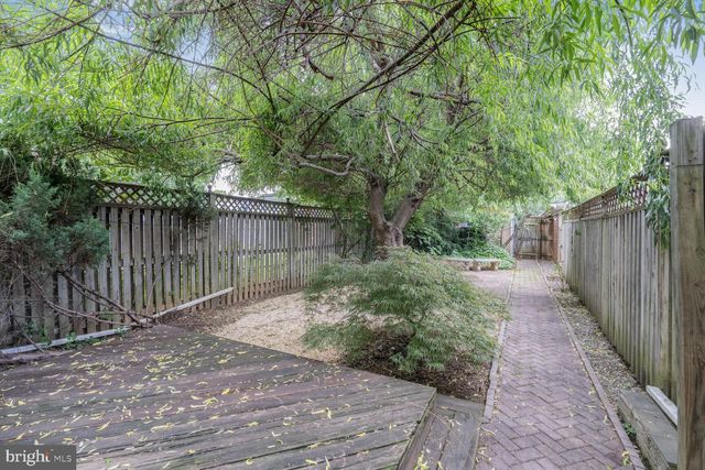 a view of a pathway with a wrought fence