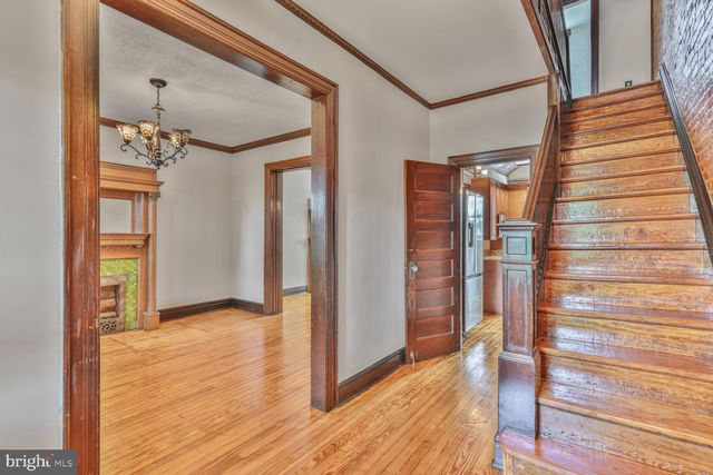 a view of hallway with wooden floor and stairs