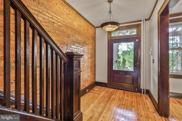 a view of hallway with wooden floor and stairs