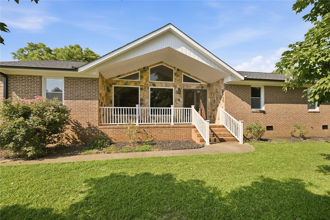 902 Cherokee Road Pelzer, SC 29669 - Photo 21 of 38 A classic brick exterior meets a distinctive stone facade, offering captivating curb appeal.