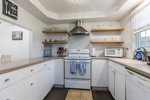 a en suite bathroom with a sink and a washing machine with the view of bathroom