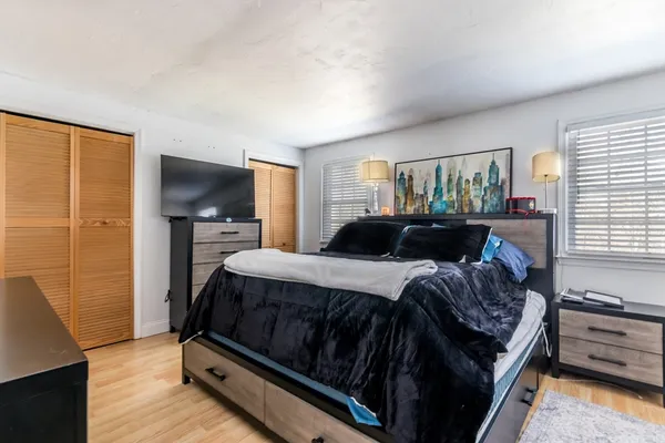 a bedroom with a bed and a flat screen tv