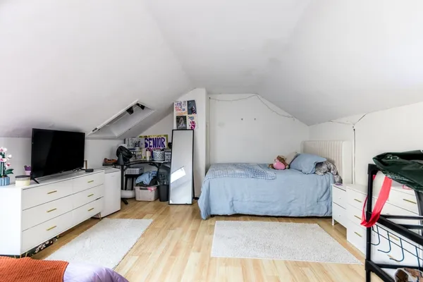 a bedroom with furniture a flat screen tv and a bed