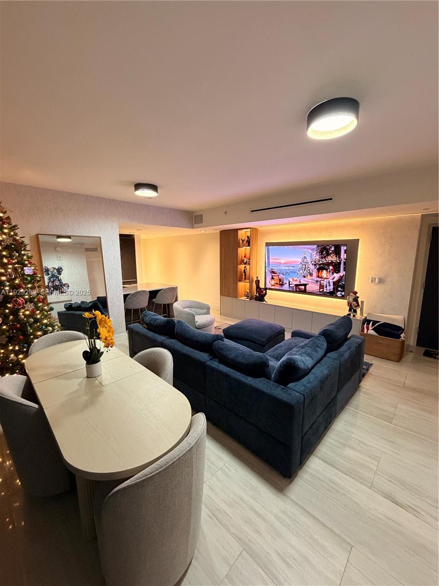 1451 Brickell Avenue, Unit 1105 Miami, FL 33131 - Photo 1 of 43 a living room with furniture and a flat screen tv